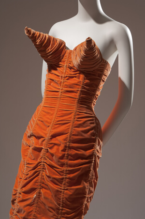 Jean Paul Gaultier’ orange shirred velvet dress with cone bust and back lacing, 1984 | THE MUSEUM AT FIT