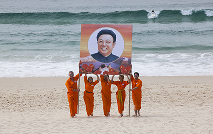 A banner honoring North Korean leader Kim Jong-um is held aloft in Anna Broinowski’s “Aim High in Creation!" | NEW YORK ASIAN FILM FESTIVAL