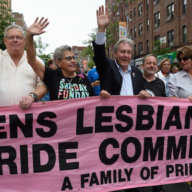 Daniel Dromm (center) holds the original Queens Pride banner at the borough's 2017 march.