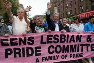 Daniel Dromm (center) holds the original Queens Pride banner at the borough's 2017 march.