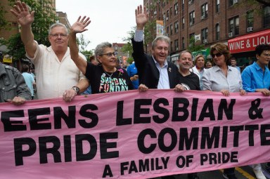 Daniel Dromm (center) holds the original Queens Pride banner at the borough's 2017 march.