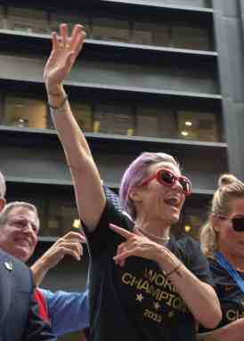 Out lesbian co-captain Megan Rapinoe waves to the crowd as the US women's soccer team rides through the Canyon of Heroes on Lower Broadway in 2019 to celebrate their World Cup victory three days before.