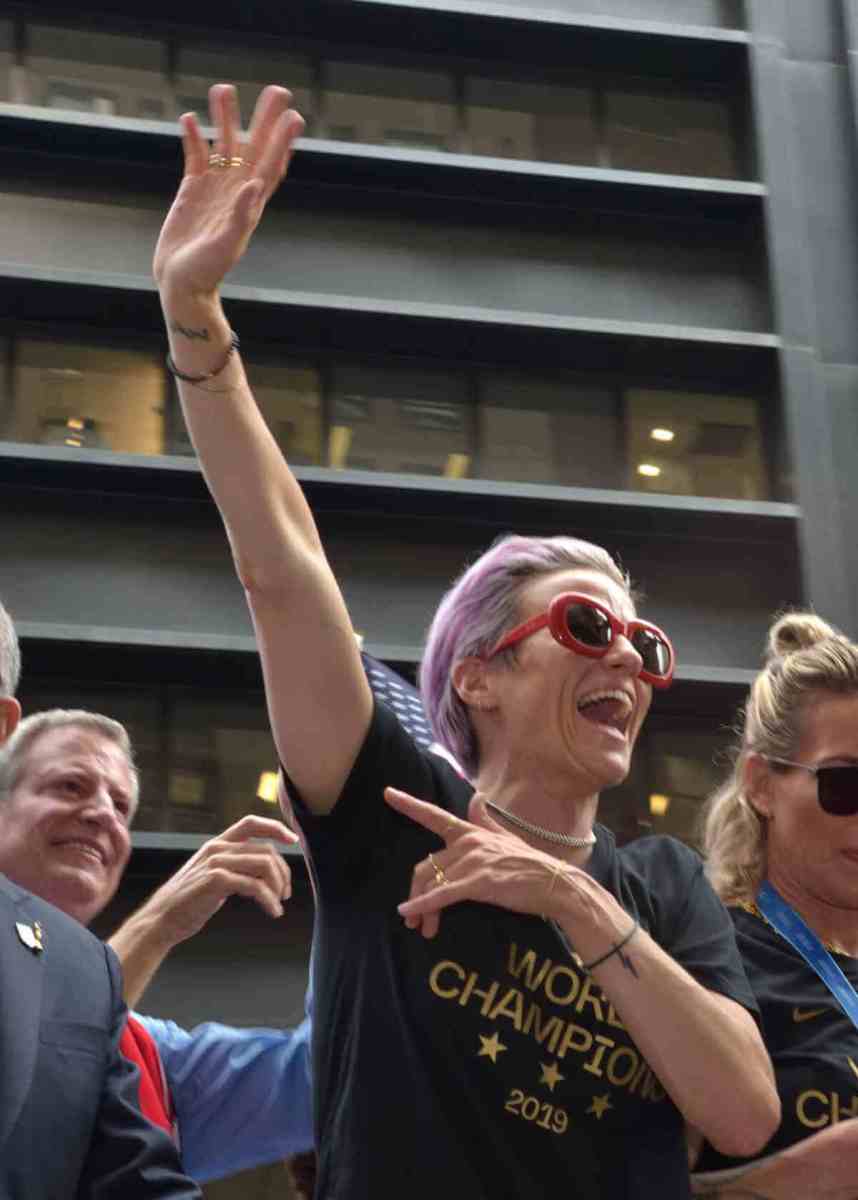 Out lesbian co-captain Megan Rapinoe waves to the crowd as the US women's soccer team rides through the Canyon of Heroes on Lower Broadway in 2019 to celebrate their World Cup victory three days before.