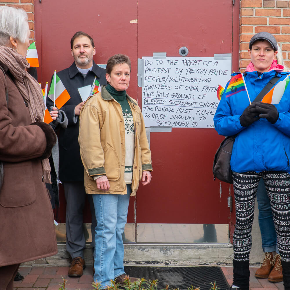 Carol Bullock and the Staten Island Pride Center stand in front of a door.