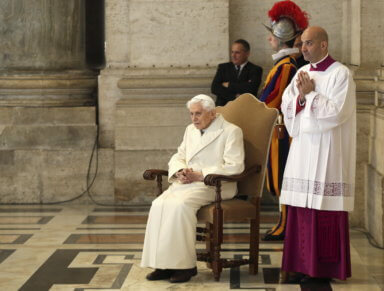 Emeritus Pope Benedict XVI sits near the Holy Door as Pope Francis leads a mass to mark opening of the Catholic Holy Year, or Jubilee, in St. Peter’s Square, at the Vatican