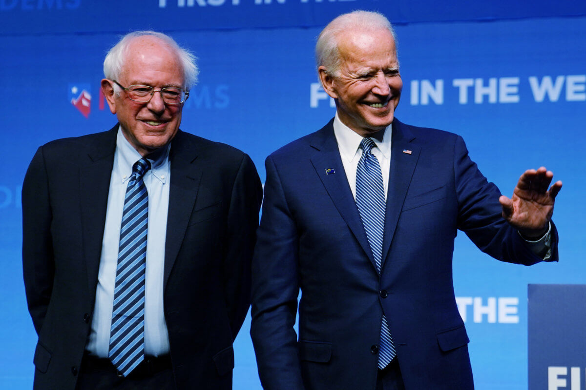 Bernie Sanders and Joe Biden are pictured on stage at a First in the West Event at the Bellagio Hotel in Las Vegas