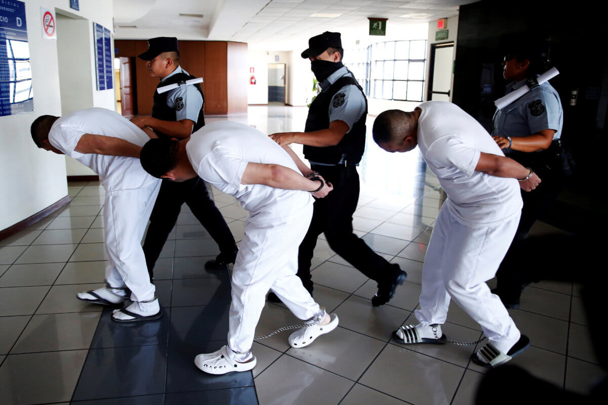 Three former police officers are taken to a hearing as they face charges for aggravated homicide and the kidnapping of Camila Diaz Cordova, a transgender woman, in San Salvador