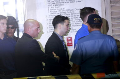 U.S. Marine Lance Corporal Joseph Scott Pemberton is escorted by U.S. security into a court in Olongapo city, north of Manila