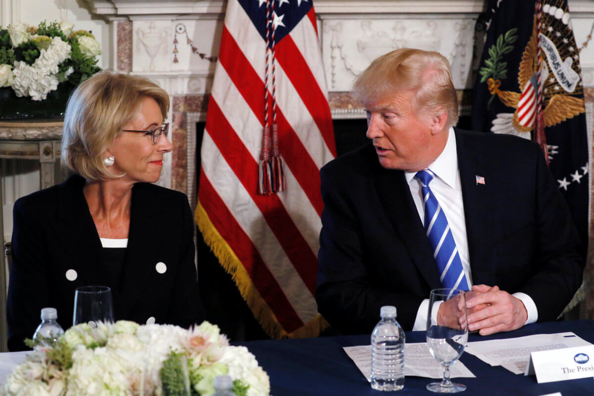 Trump turns to DeVos during his remarks to reporters before workforce discussion in Bedminster, New Jersey