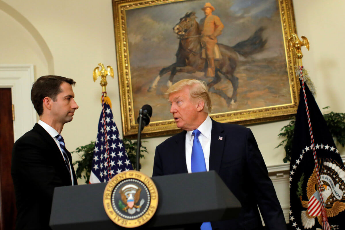 U.S. President Donald Trump leaves after delivering remarks on immigration reform, accompanied by Senator Tom Cotton in the Roosevelt Room of the White House in Washington