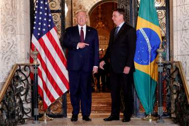 FILE PHOTO: U.S. President Donald Trump participates in a working dinner with Brazilian President Jair Bolsonaro at the Mar-a-Lago resort in Palm Beach, Florida