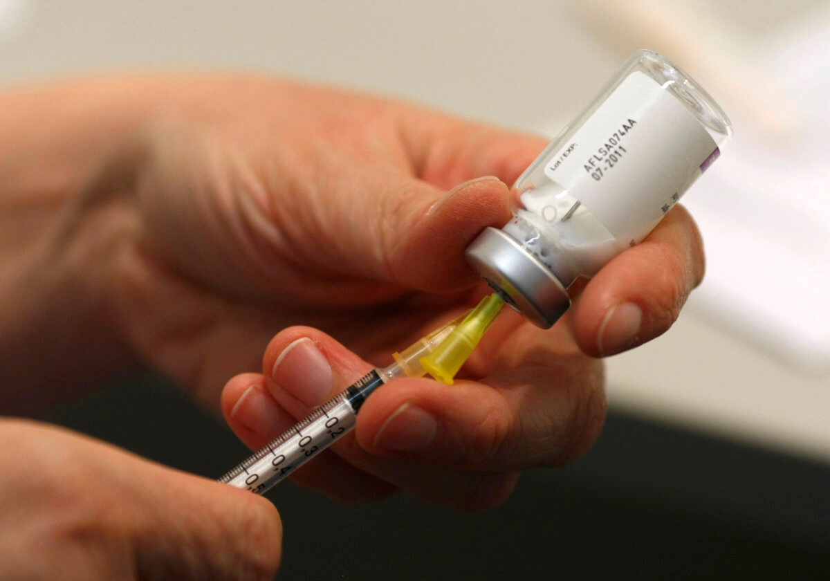A doctor prepares a syringe for a H1N1 swine flu vaccination at a vaccination centre of the local public health department in Duesseldorf