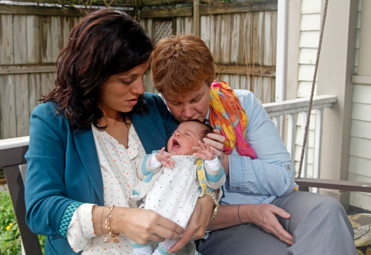 Valeria Tanco and Sophy Jesty pose with their new baby girl in Knoxville