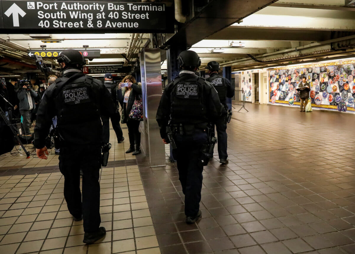 Members of the Port Authority Police Counter Terrorism unit patrol the subway corridor, at the New York Port Authority subway station near the site of an attempted detonation the day before, during the morning rush in New York