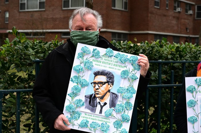 Walter Naegle holds artwork paying tribute to his late partner, Bayard Rustin, in commemoration of his birthday on March 17, 2021.