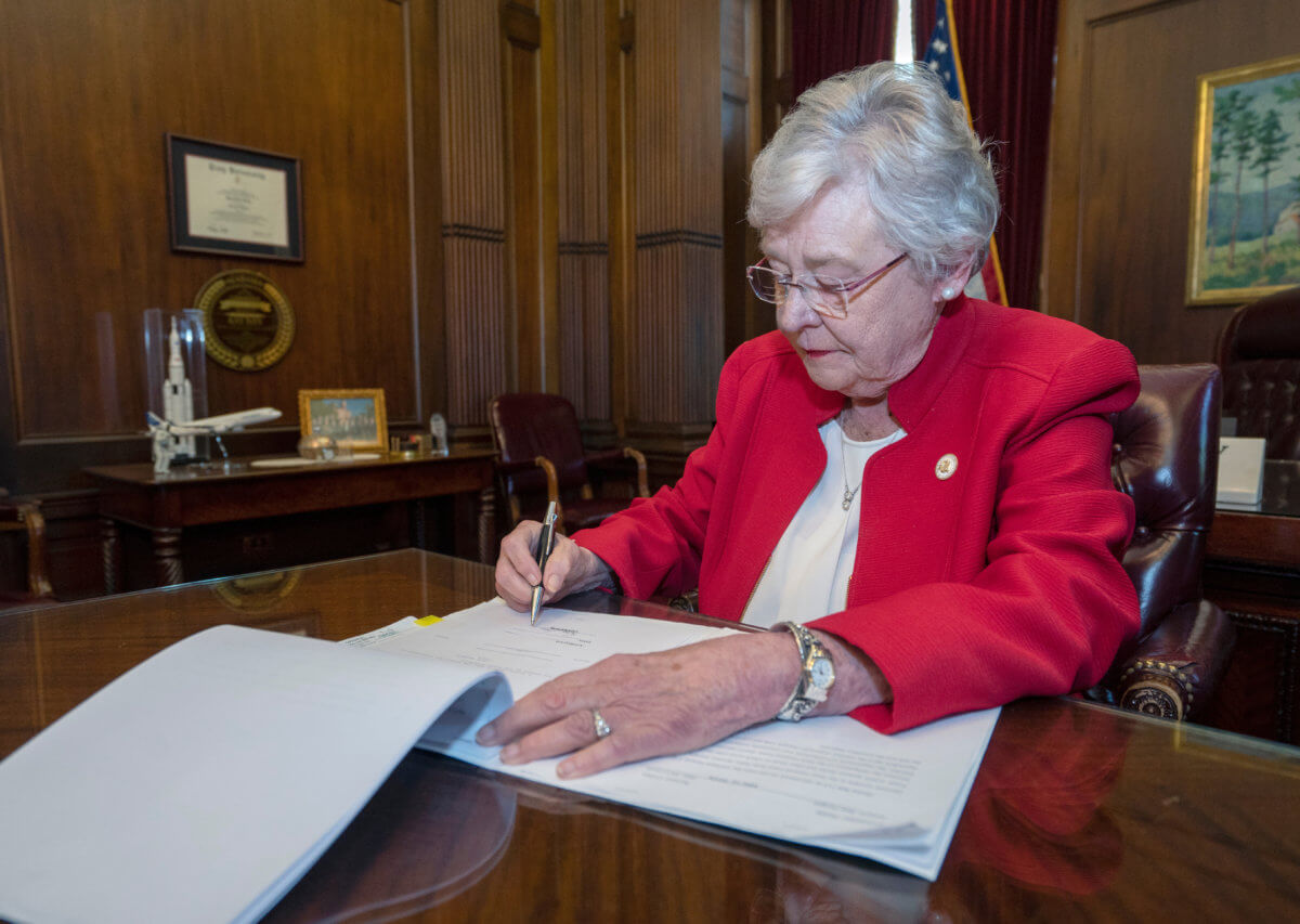 Handout photo of Alabama Governor Kay Ivey signing into law the Alabama Human Life Protection Act in Montgomery