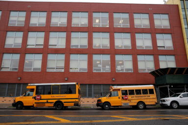 School busses are parked outside a school in Brooklyn, New York