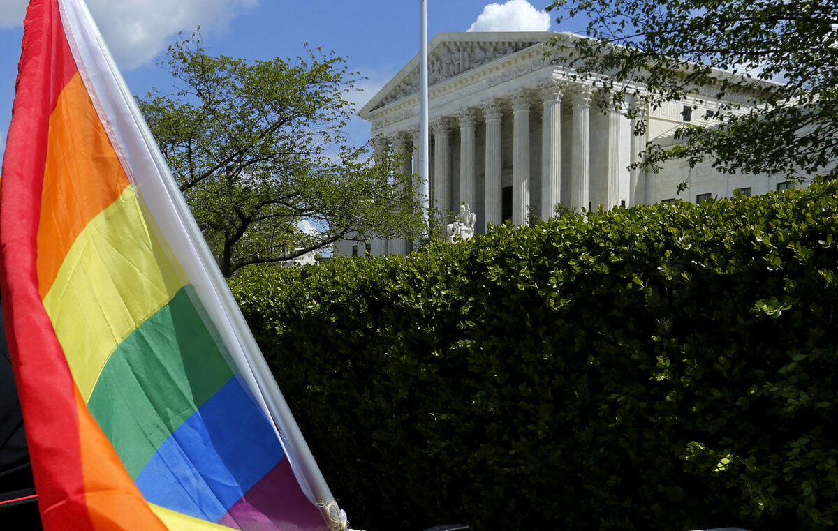 FILE PHOTO: A rainbow colored flag is seen outside the U.S. Supreme Court in Washington