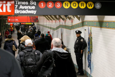 A New York City Police (NYPD) officer stands in the subway corridor, at the New York Port Authority subway station near the site of an attempted detonation the day before, in New York