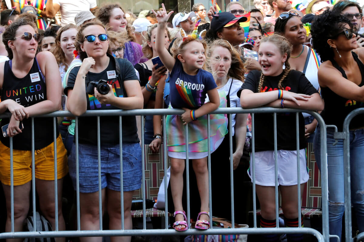 Young girl cheers as she watches 2019 World Pride NYC and Stonewall 50th LGBTQ Pride Parade in New York