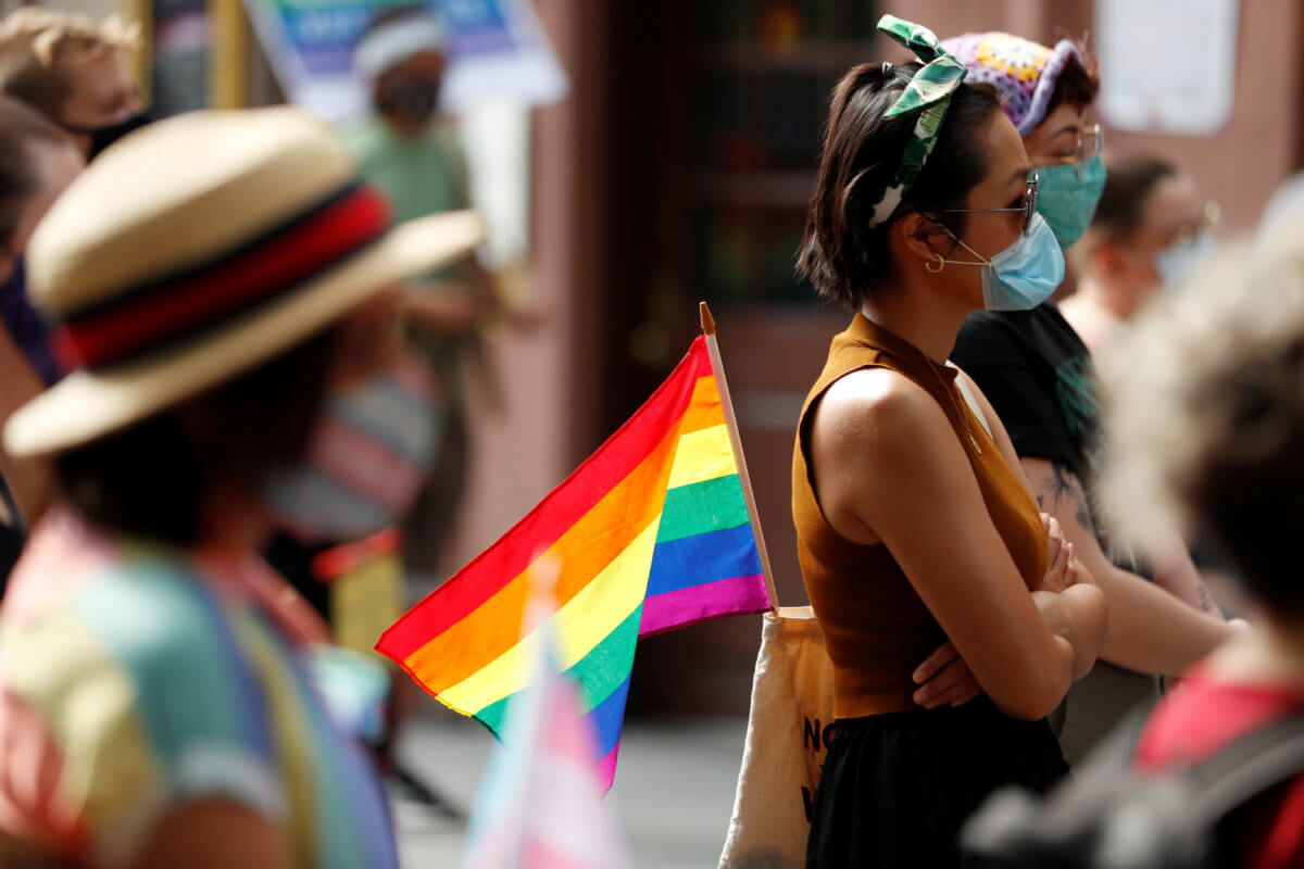 An attendee listens to speakers voice their support for gay pride and black lives matter movements in New York City, New York