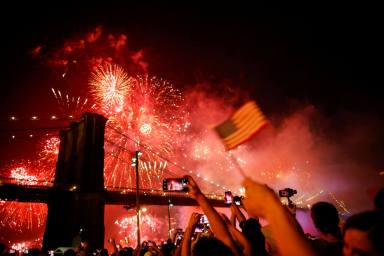FILE PHOTO: People watch the Macy’s 4th of July Firework Show over the Brooklyn Bridge in New York