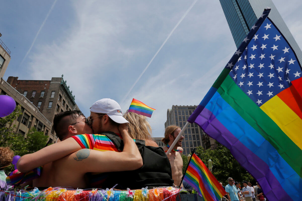Revellers kiss before the start of Boston’s 48th Pride Parade in Boston