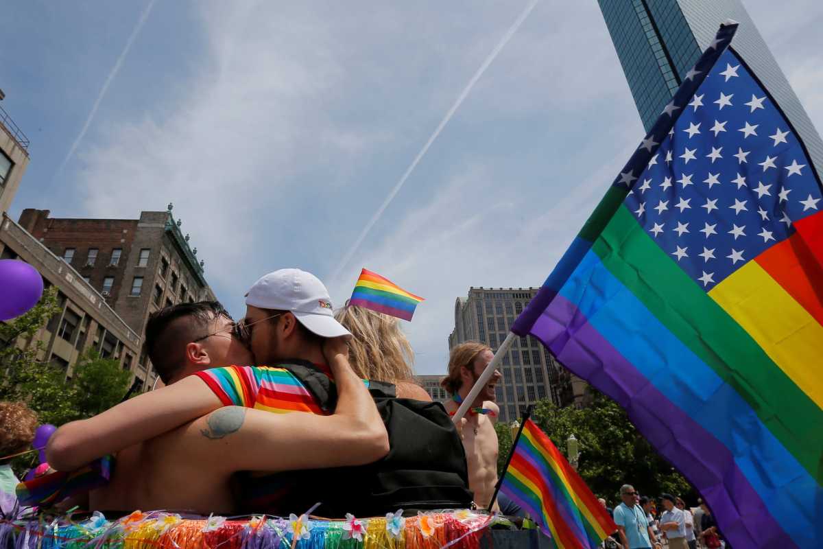 Revellers kiss before the start of Boston’s 48th Pride Parade in Boston