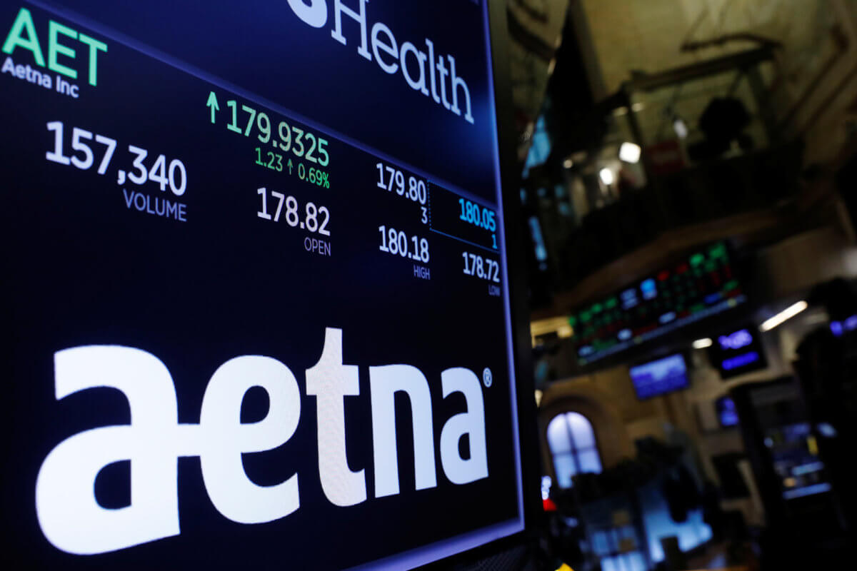 A logo of Aetna is displayed on a monitor above the floor of the New York Stock Exchange shortly after the opening bell in New York
