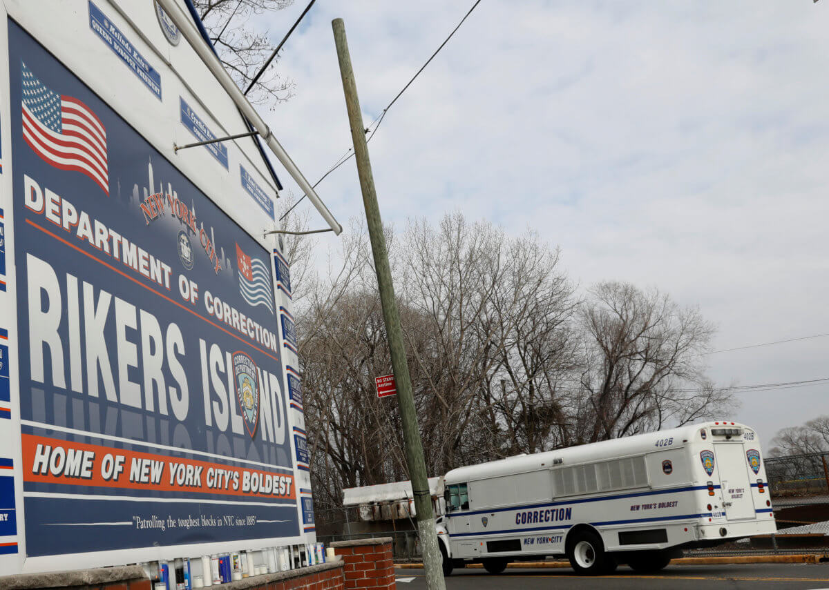 An NYC Department of Corrections vehicle drives in the entrance to Rikers Island facility in Queens, in New York