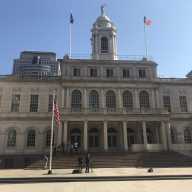 A view of the front steps of New York City Hall.