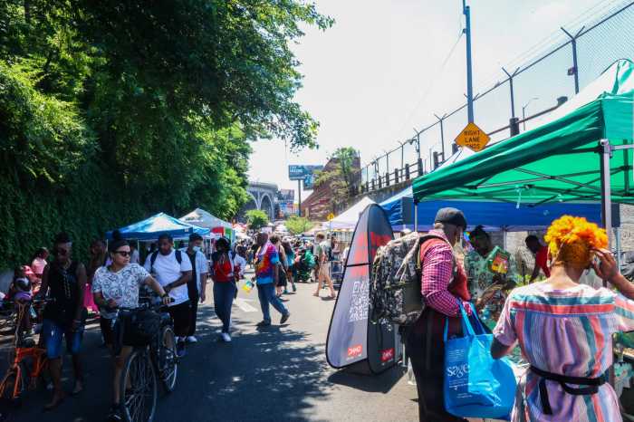 Locals check out the tents perched on the side during Harlem Pride in 2022.