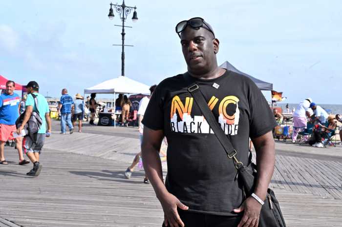 Lee Soulja-Simmons, the leader of NYC Black Pride, pauses for a picture during NYC Black Pride's 2022 beach event.