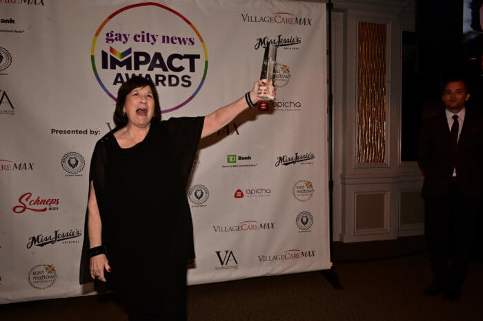 Honoree Evie Litwok celebrates after receiving an Impact Award.