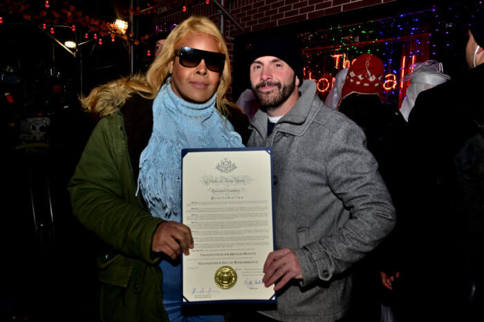 Ron Zacchi and Chanel Lopez hold a proclamation from Governor Kathy Hochul recognizing November as Transgender Remembrance Month.