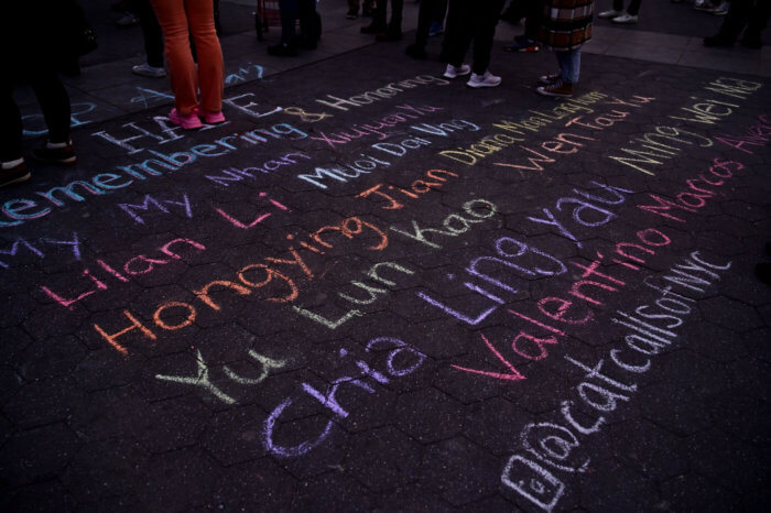 Names of slain individuals etched in chalk at Washington Square.
