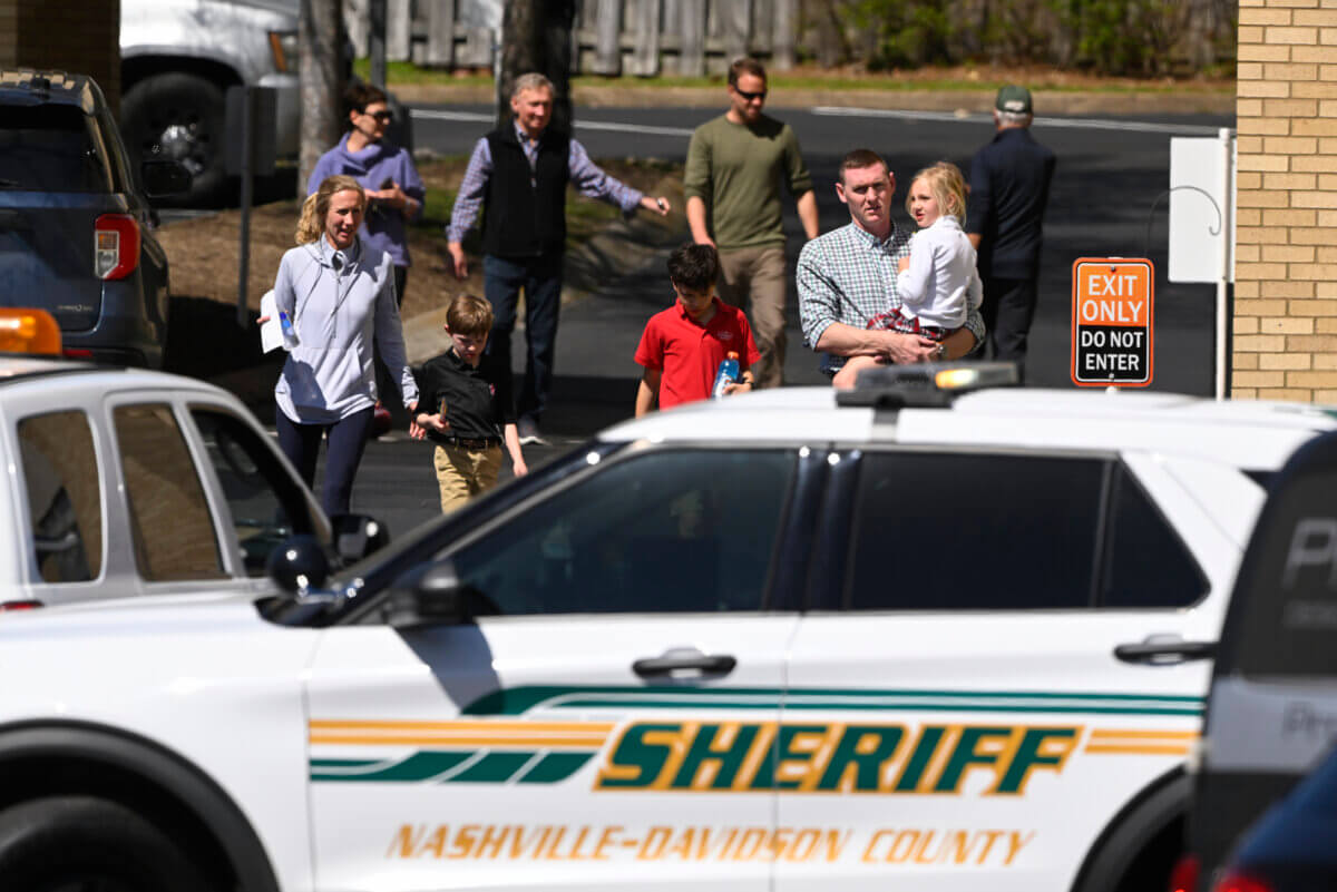 Families leave a reunification site in Nashville, Tenn., Monday, March 27, 2023 after several children were killed in a shooting at Covenant School in Nashville.