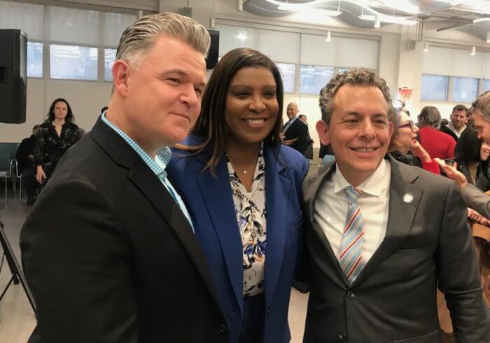 Assemblymember Tony Simone (right) and his partner, Jason (left) take a picture with New York Attorney General Letitia James.