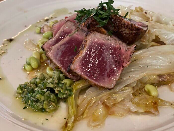 Superfine’s pan-seared local Bluefin tuna on a bed of Italian chicory and fast lady cow peas with green olive salsa.