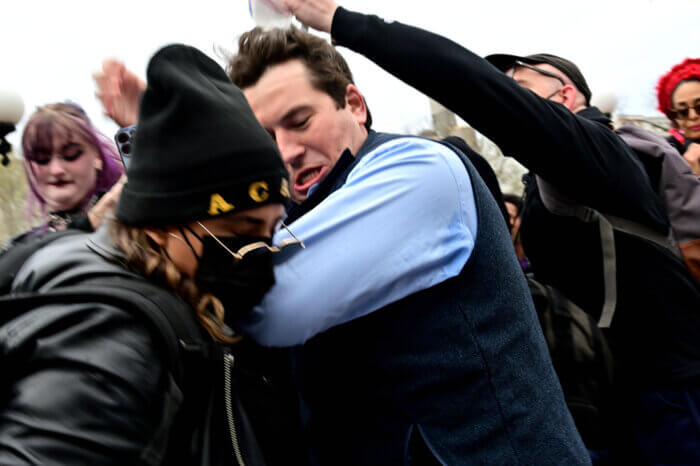 A counter-protestor engages in a brief altercation.