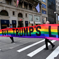 Gilbert Baker's "DON'T BUY TRUMP'S LIES" banner crosses the street.