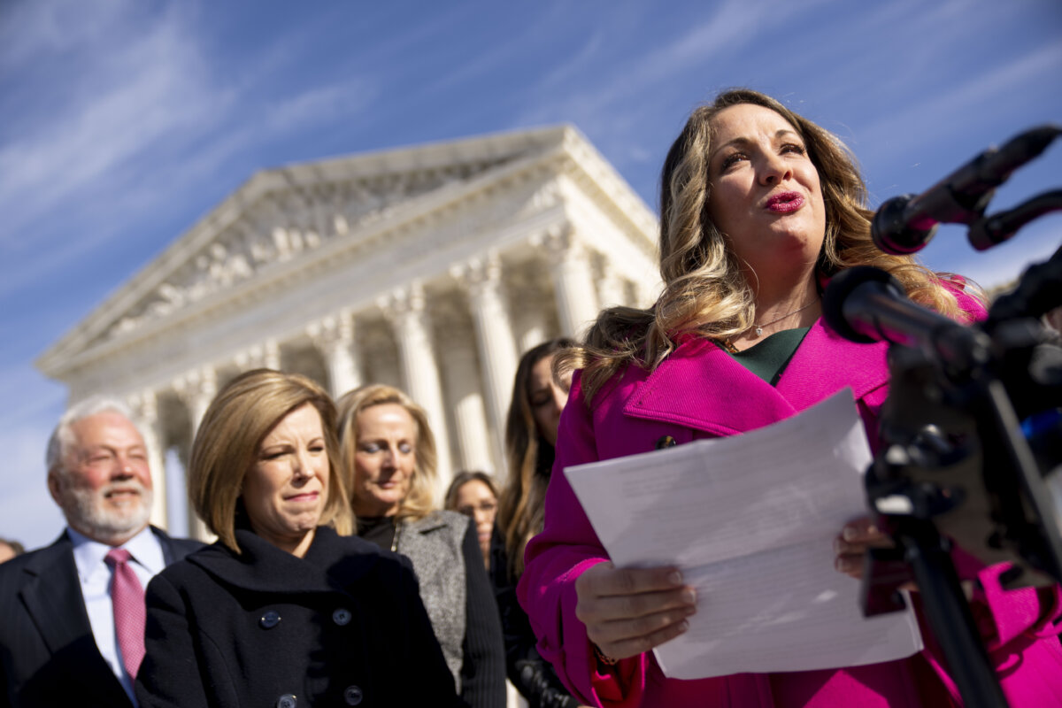 Lorie Smith, a Christian graphic artist and website designer in Colorado, right, accompanied by her lawyer, Kristen Waggoner of the Alliance Defending Freedom, second from left, speaks outside the Supreme Court in Washington, Monday, Dec. 5, 2022, after her case was heard before the Supreme Court.