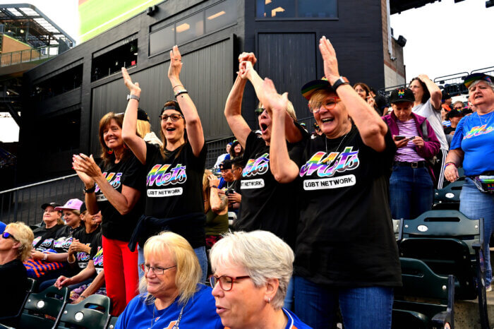 Dedicated dancing dykes show their support for the Mets.