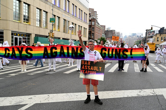 The Gays Against Guns banner takes up the entire street.