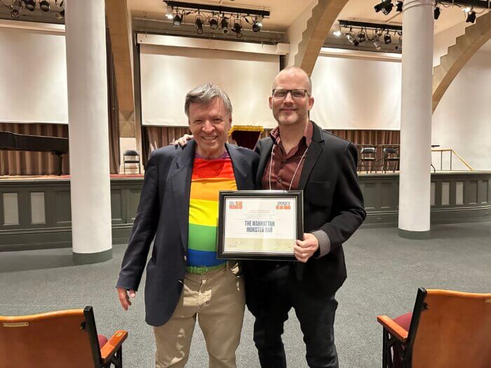 Musician Martin St. Lawrence (left) and general manager Daniel Tobey (right) accept the 2023 Village Award for The Monster Bar from Village Preservation at Cooper Union’s Great Hall on June 13.