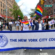 LGBTQIA+ Caucus Co-Chairs Tiffany Cabán of Queens and Crystal Hudson of Brooklyn leads the City Council's banner.