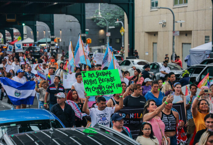 Marchers hold Trans Flags and signs at the TransLatinx March.