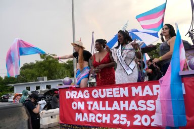 Nic Zantop, left, waves a Trans Flag while on a float sponsored by several transgender groups, with Tiffany Arieagus, second from left, and Miss Naples Pride Velvet Lenore, second from right, during the Stonewall Pride Parade and Street Festival, Saturday, June 17, 2023, in Wilton Manors, Fla.