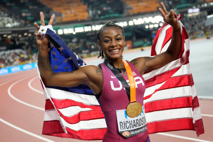 Sha'Carri Richardson poses after winning the gold medal in the Women's 100-meter final during the World Athletics Championships in Budapest, Hungary, Monday, Aug. 21, 2023.