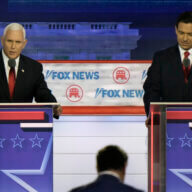 Former Vice President Mike Pence speaks as Florida Gov. Ron DeSantis listens during a Republican presidential primary debate hosted by FOX News Channel Wednesday, Aug. 23, 2023, in Milwaukee.